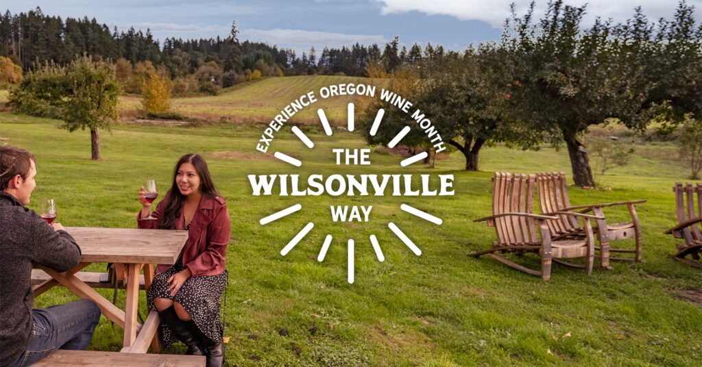 Experience Oregon Wine Month the Wilsonville Way logo over a couple drinking wine at a vineyard
