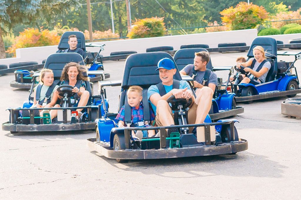 Parents driving go-karts with their children