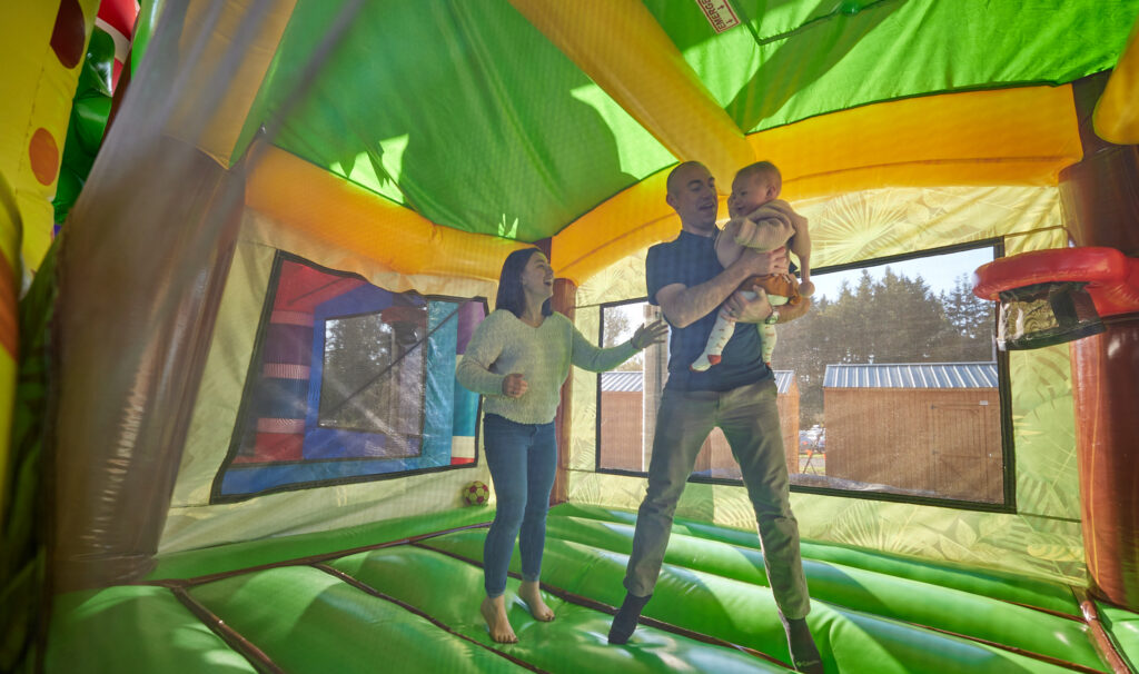 photo of family in bouncy house in Wilsonville, Oregon, cover photo of itinerary