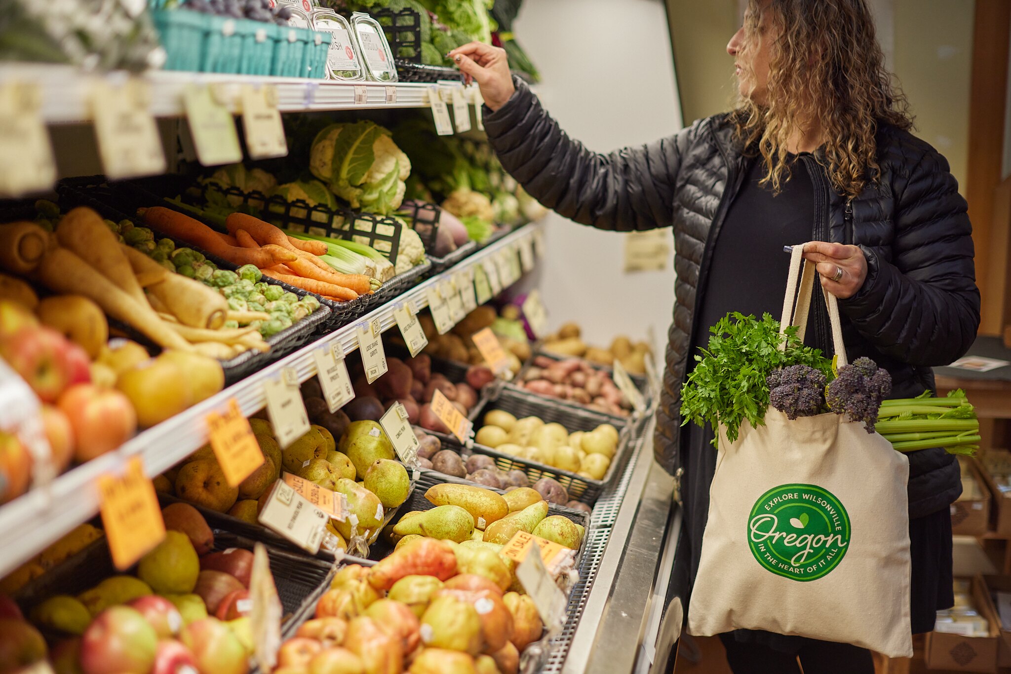photo of a shopper looking at produce at the Our Table Cooperative Grocery store near Wilsonville, Oregon
