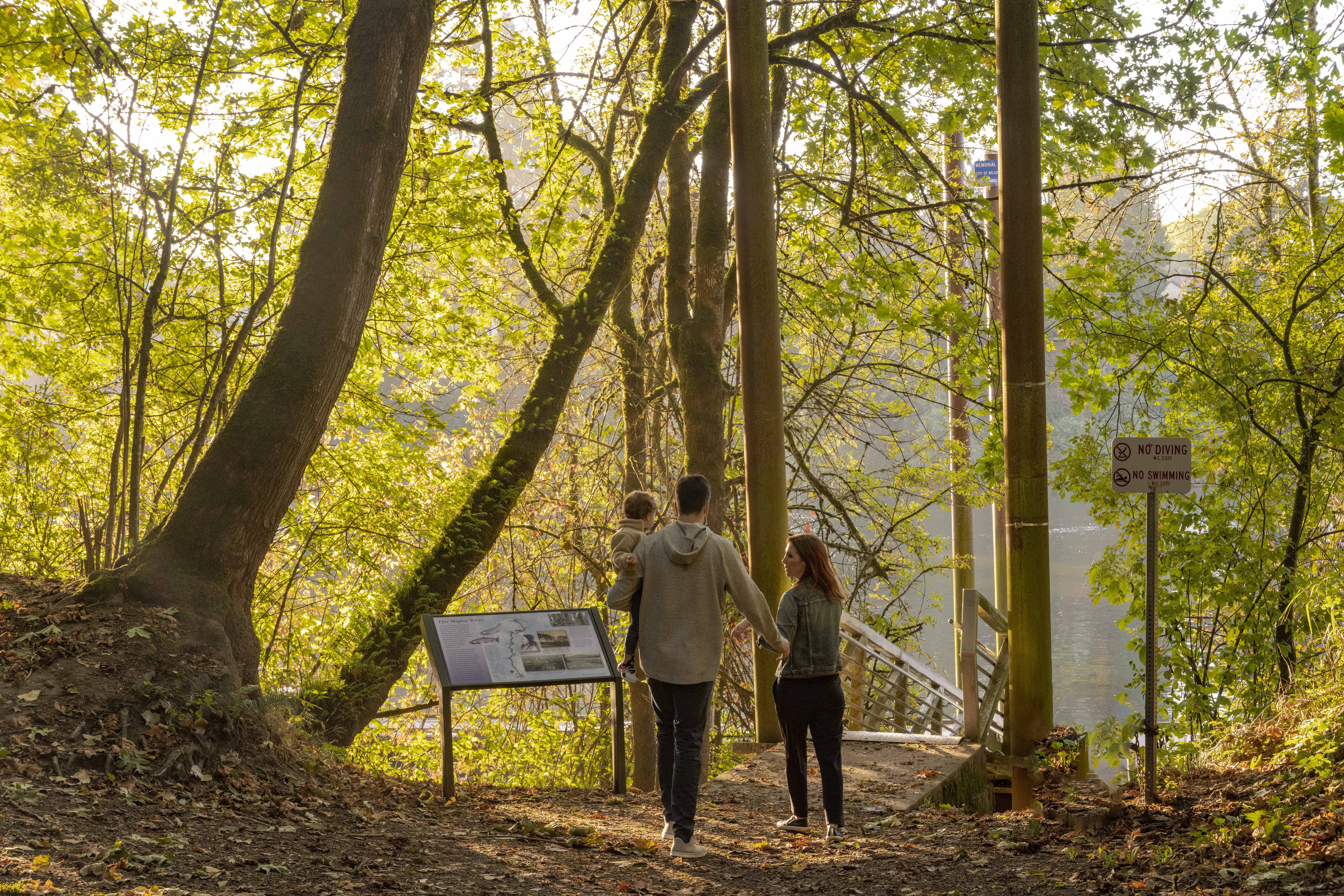 Photo of a family walking through forest in Memorial Park in Wilsonville, Oregon