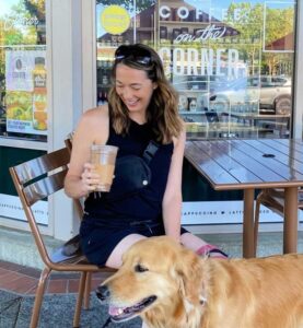 Woman drinking coffee with her Golden Retriever outside
