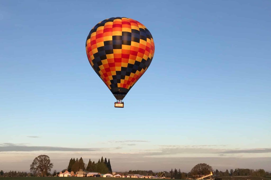 Hot air balloon floating over a town
