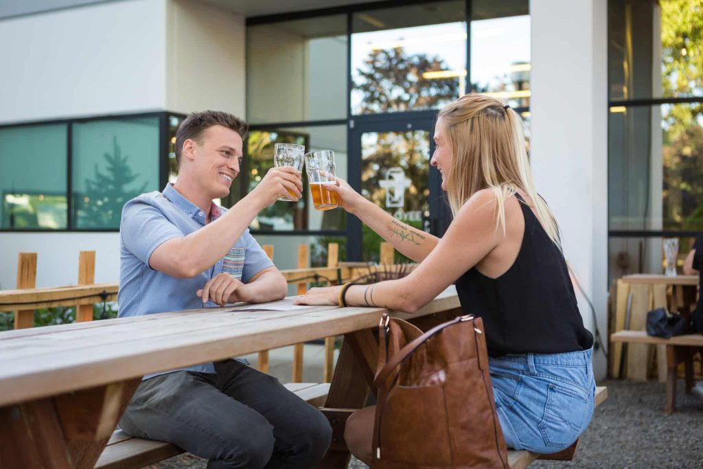 Couple toasting beer at Vanguard Brewing's outdoor beer garden