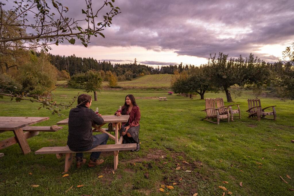 A couple enjoys their wine outside at Lady Hill Winery