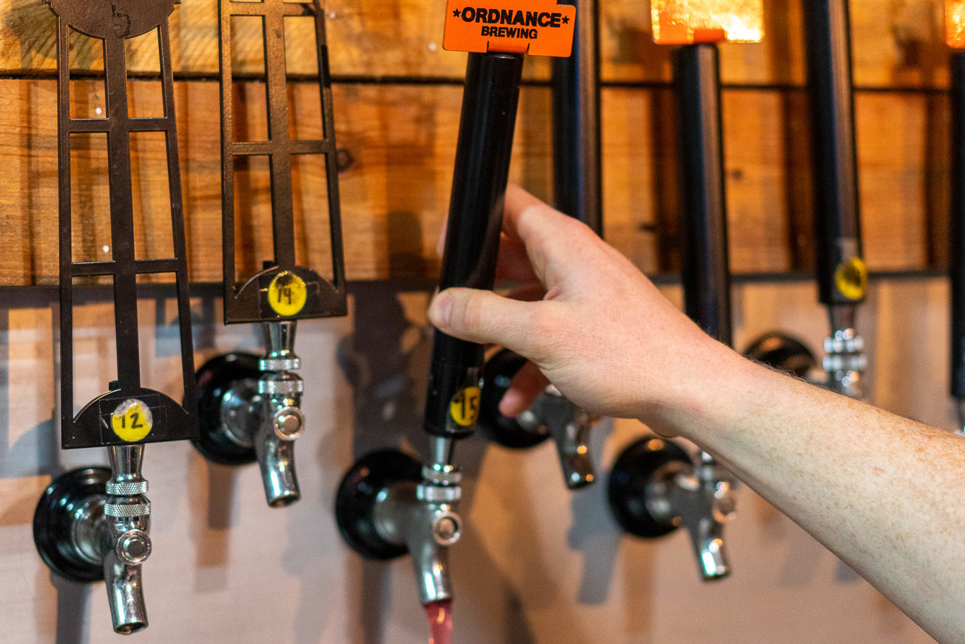 Man holding a beer tap at Ordnance Brewing