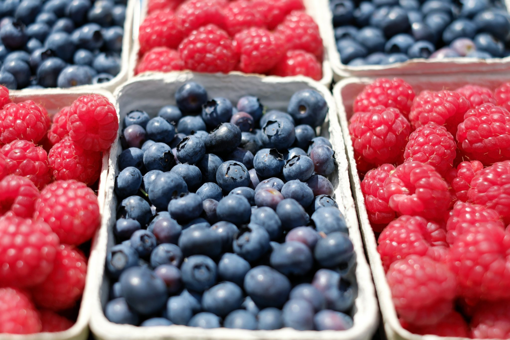 Trays of blueberries and raspberries