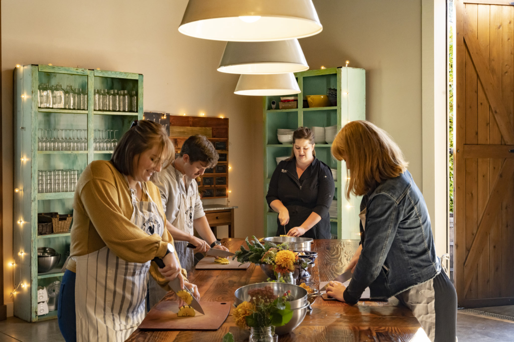 Three people participating at a cooking class at the Kitchen at Middleground Farms