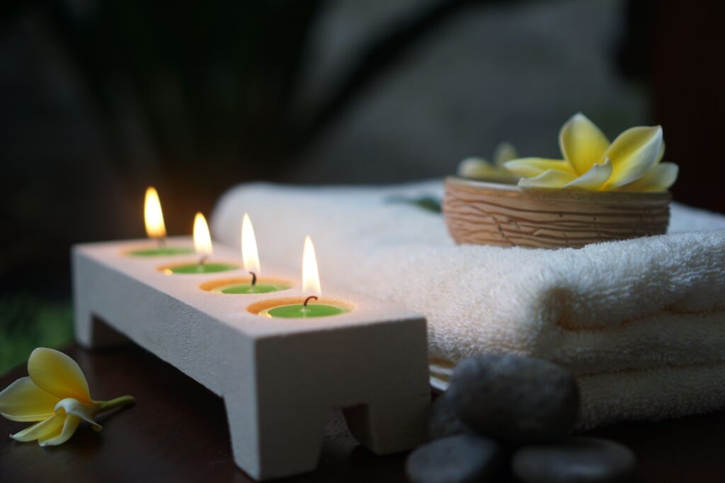 itinerary cover photo that shows candles and towels with yellow flowers on a table