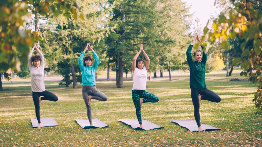 People participating in a yoga class at a public park