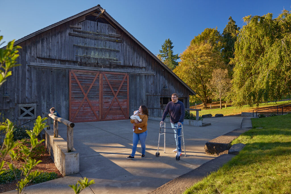 photo of a family walking through Memorial Park by the Stein Boozier Barn in Wilsonville, Oregon