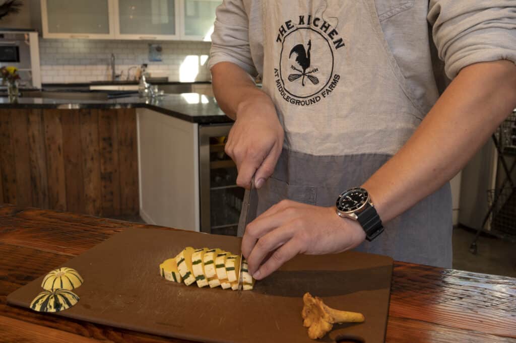 Photo of a chef/instructor chopping a gourd in The Kitchen at Middleground Farms (Must-Do Fall Activities In and Around Wilsonville)