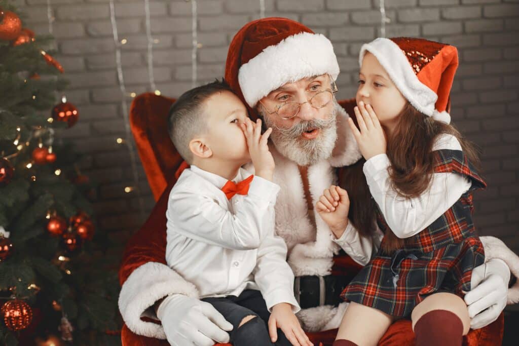 photo of Santa listening to what children want for Christmas