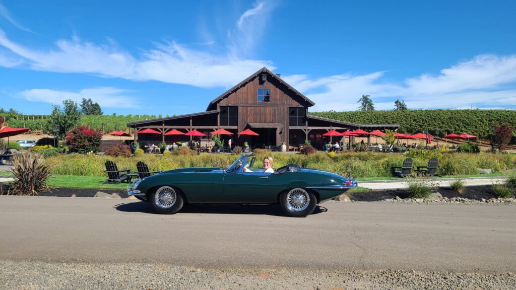 photo of a classic green Jaguar car in front of Tumwater Vineyard during Corks and Cars