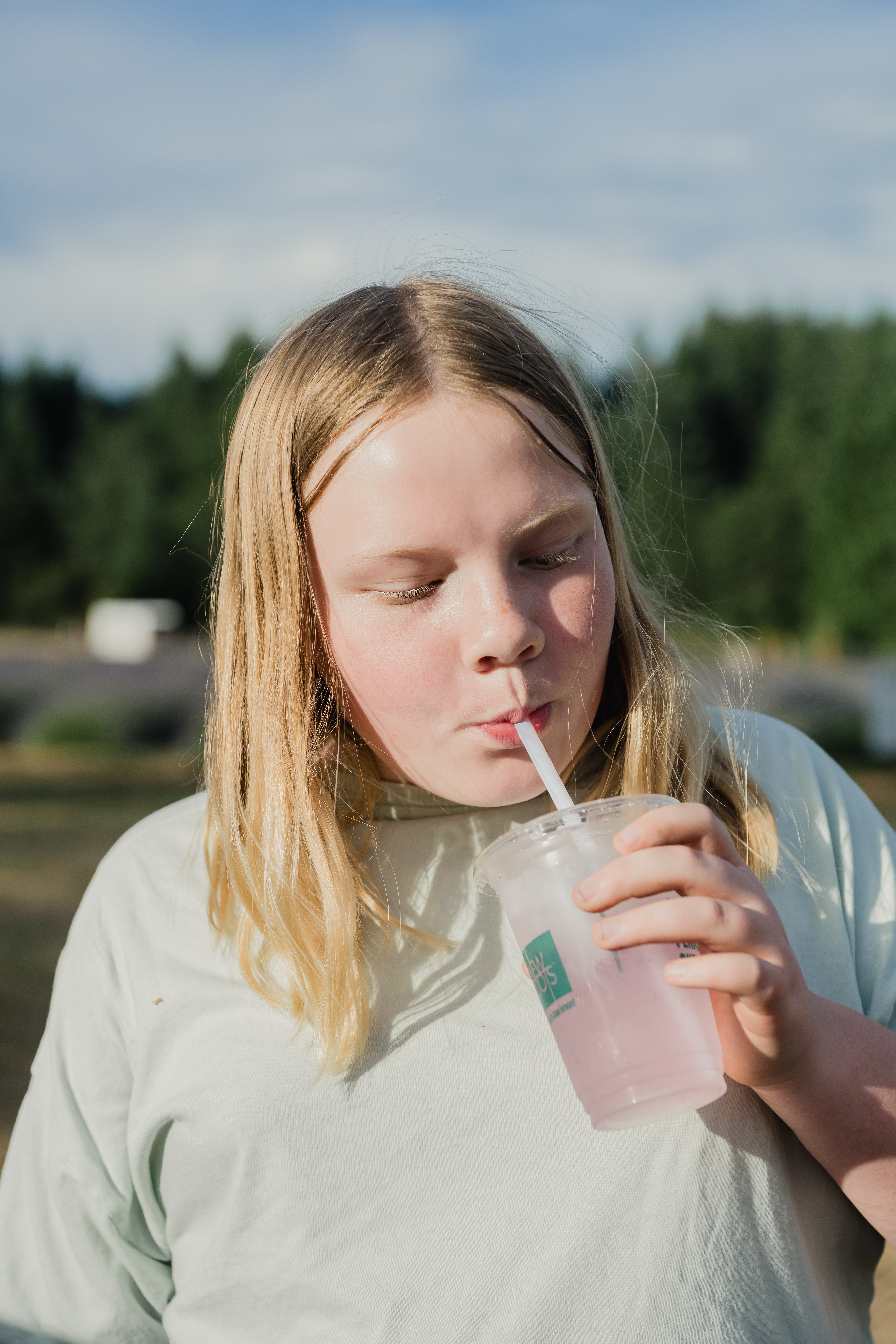 photo of a child drinking a lavender lemonade at Thistle & Bloom Lavender Farm near Wilsonville, Oregon